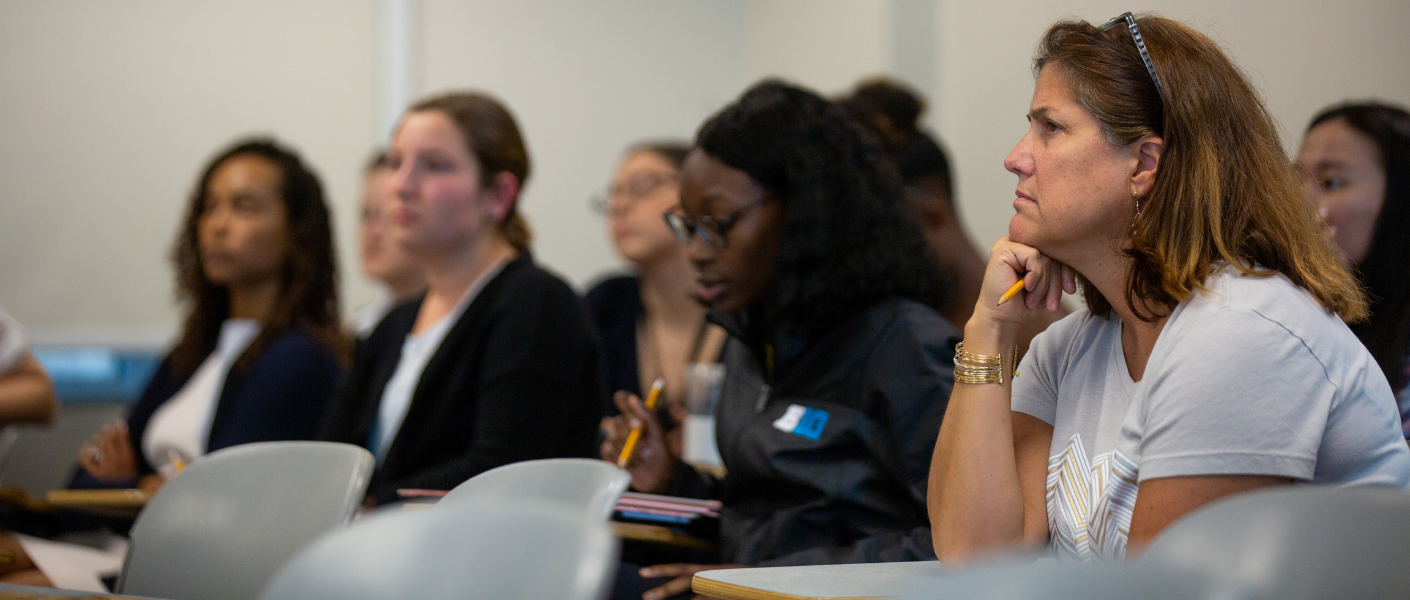 Graduate students sit in a classroom